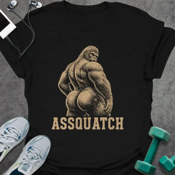 Black t-shirt printed with "Assquatch" in white, with an illustration of Bigfoot from behind