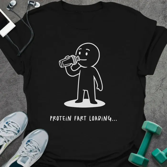 Black t-shirt printed with "Protein Fart Loading...", with an illustration of a stick figure drinking protein