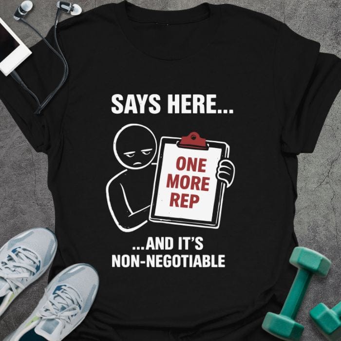 Black t-shirt printed with "Says Here... One More Rep ...and It's Non-negotiable" in white, red, with a stick figure holding a clipboard