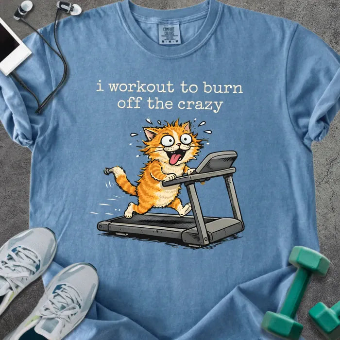 Blue jean t-shirt printed with "i workout to burn off the crazy" in orange, with a cat running on a treadmill