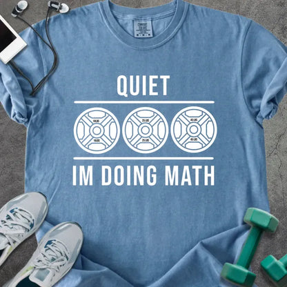 Blue jean t-shirt printed with "Quiet Im Doing Math" in white, with three weight plate graphics