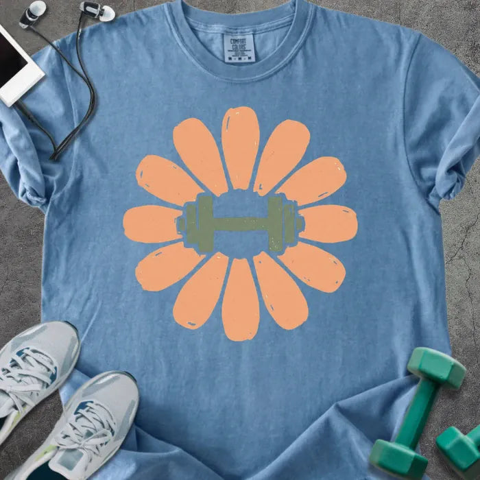 Blue jean t-shirt with coral/peach flower and dumbbell in center in peach and green