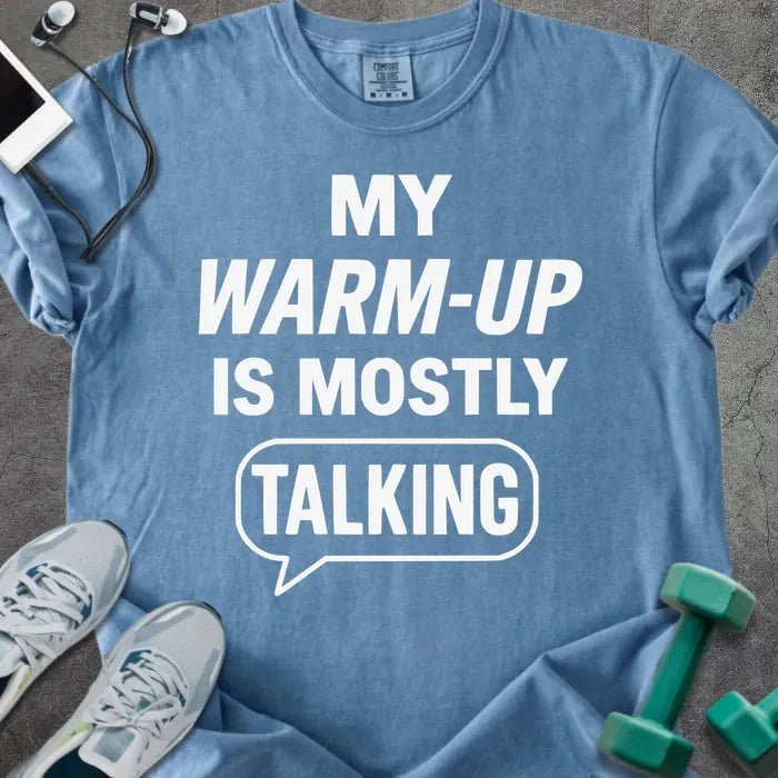 Blue jean t-shirt printed with "My Warm-up is Mostly Talking" in white, with a speech bubble graphic