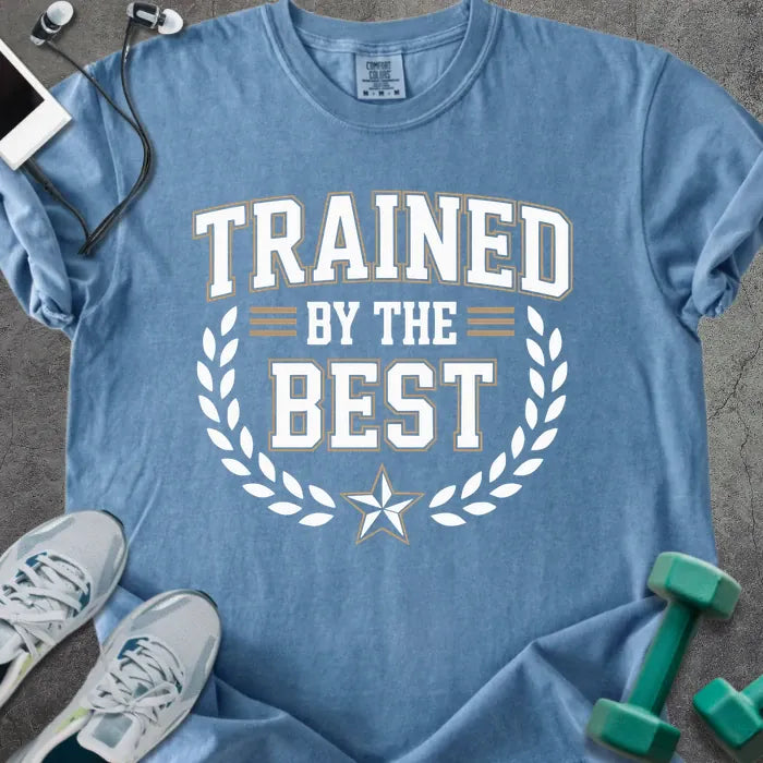 Blue jean t-shirt printed with "Trained By the Best" in tan and white, with laurel wreath and star