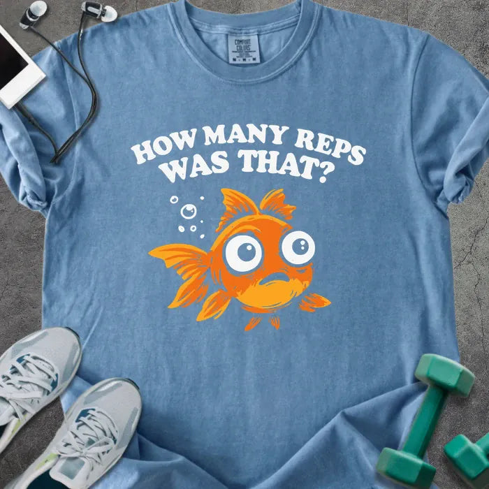 Blue jean t-shirt printed with "How Many Reps Was That?", with an illustration of a wide-eyed goldfish and bubbles