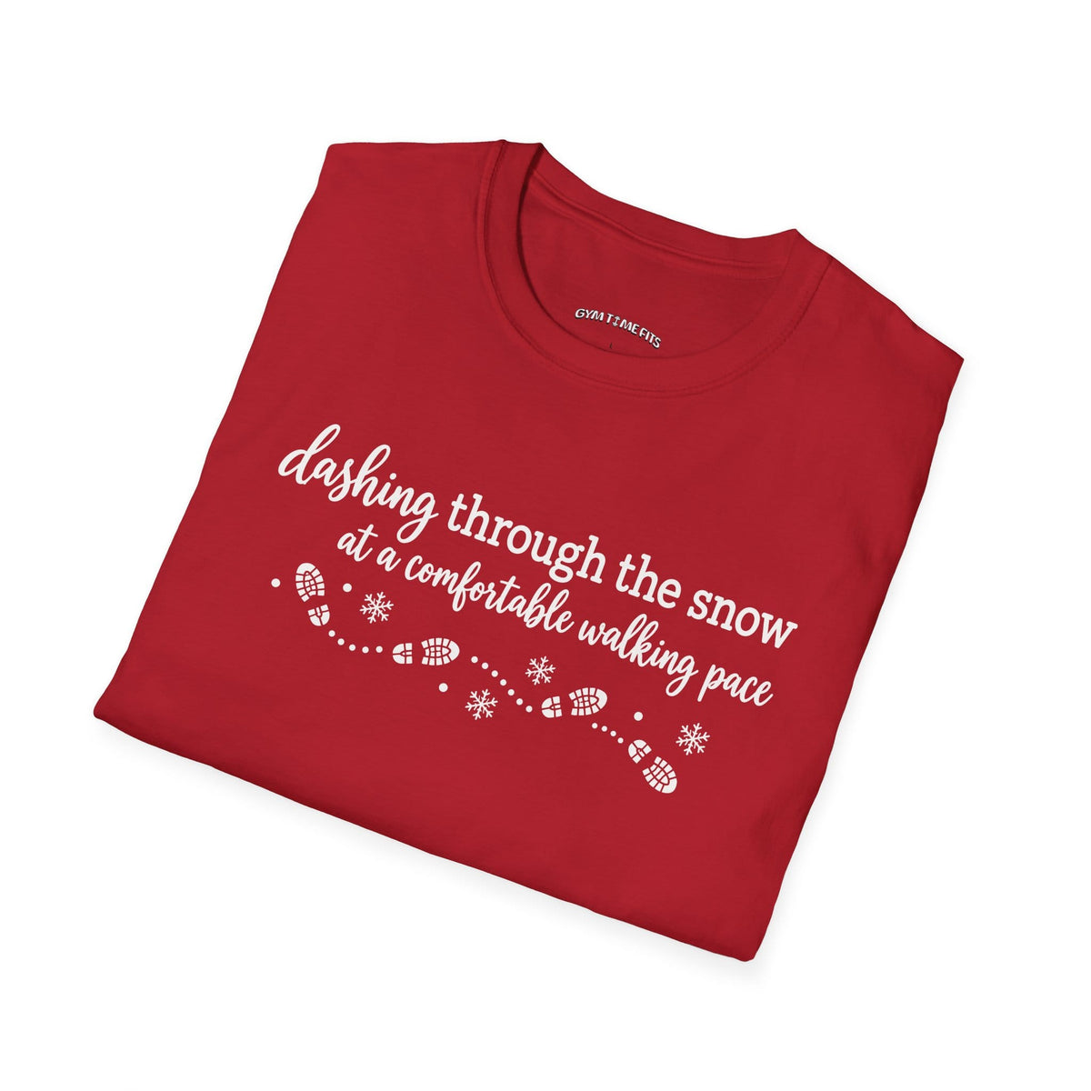 Folded cherry red t-shirt printed with "dashing through the snow at a comfortable walking pace" in white, with a dotted trail of footprints and snowflakes