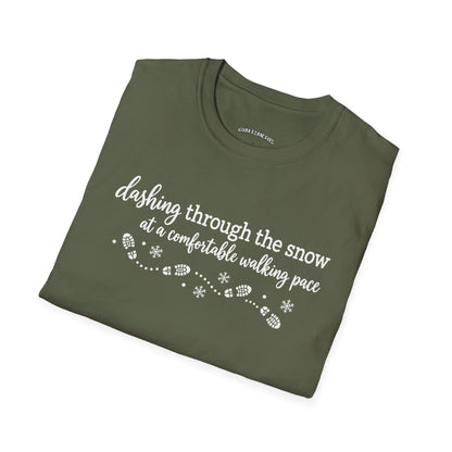 Folded military green t-shirt printed with "dashing through the snow at a comfortable walking pace" in white, with a dotted trail of footprints and snowflakes