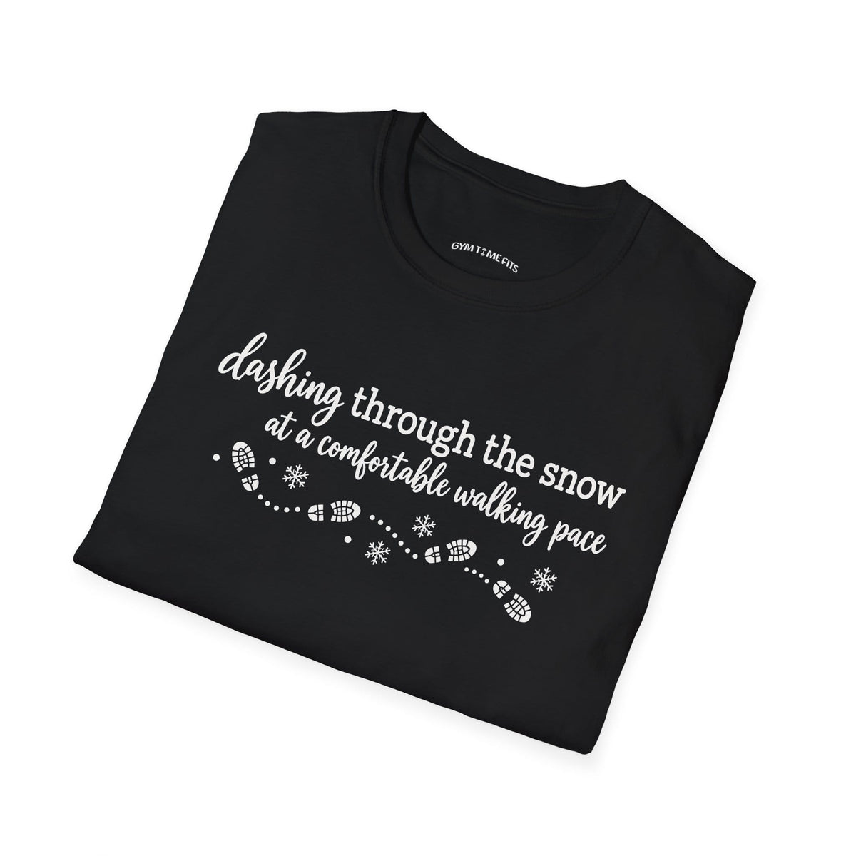Folded black t-shirt printed with "dashing through the snow at a comfortable walking pace" in white, with a dotted trail of footprints and snowflakes