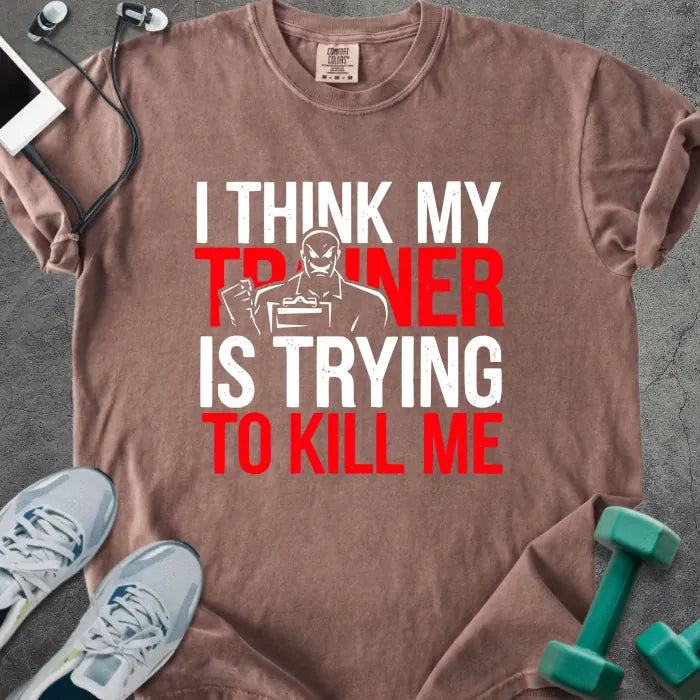 Espresso t-shirt printed with "I Think my Trainer is Trying to Kill Me" in red and white, with a trainer figure