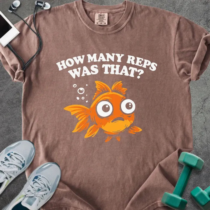 Espresso t-shirt printed with "How Many Reps Was That?", with an illustration of a wide-eyed goldfish and bubbles