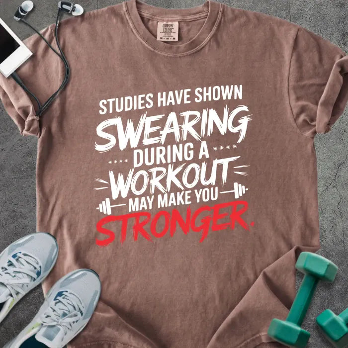 Espresso t-shirt printed with "Studies Have Shown Swearing During a Workout May Make You Stronger" in red