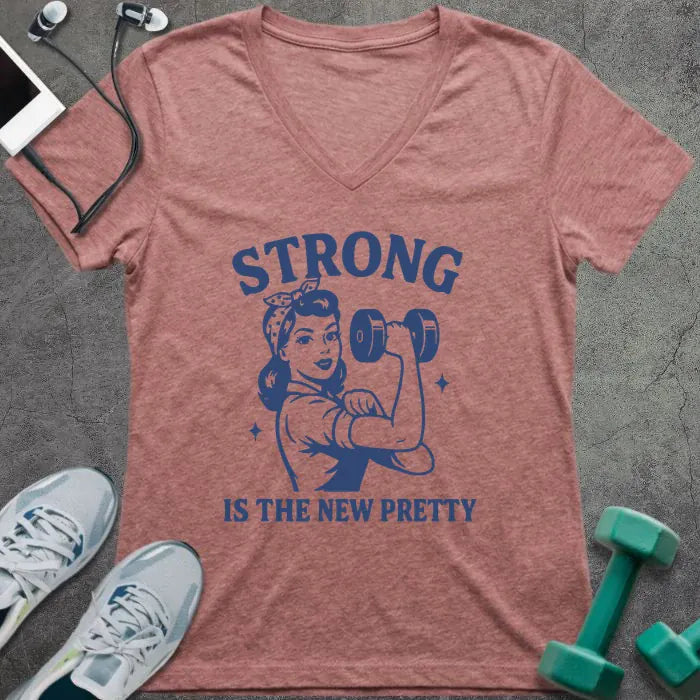 Heather mauve t-shirt printed with "Strong is the New Pretty" in blue, with a woman flexing in Rosie the Riveter style