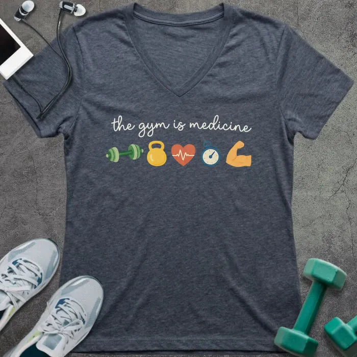 Heather navy t-shirt printed with "the gym is medicine" in yellow and orange, with dumbbell, kettlebell, heartbeat, weight scale, clock, and bicep graphics