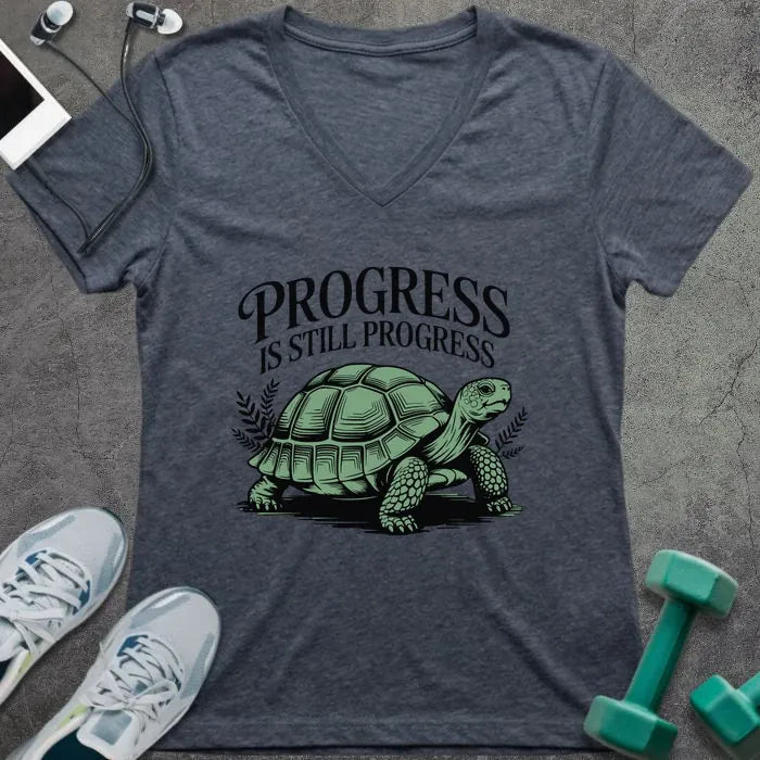 Heather navy t-shirt printed with "Progress is Still Progress" in green, with a turtle