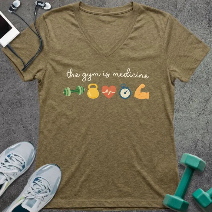 Heather olive t-shirt printed with "the gym is medicine" in yellow and orange, with dumbbell, kettlebell, heartbeat, weight scale, clock, and bicep graphics