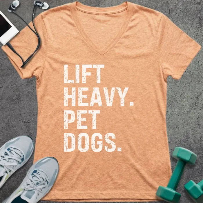 Heather peach t-shirt printed with "Lift Heavy. Pet Dogs."