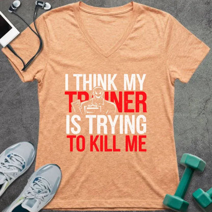 Heather peach t-shirt printed with "I Think my Trainer is Trying to Kill Me" in red and white