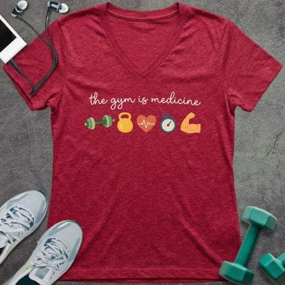 Heather red t-shirt printed with "the gym is medicine" in yellow and orange, with dumbbell, kettlebell, heartbeat, weight scale, clock, and bicep graphics