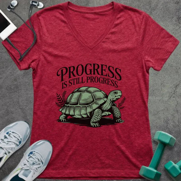 Heather red t-shirt printed with "Progress is Still Progress" in green, with a turtle
