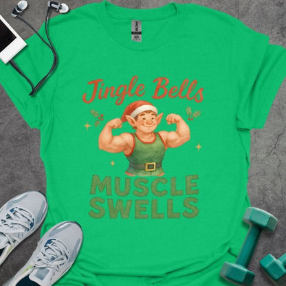 Irish green t-shirt printed with "Jingle Bells MUSCLE SWELLS" in red and green, with an illustration of a leprechaun flexing