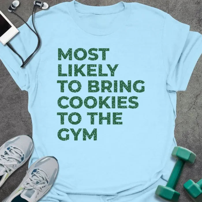 Light blue t-shirt printed with "MOST LIKELY TO BRING COOKIES TO THE GYM" in green