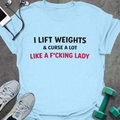 Light blue t-shirt printed with "I Lift Weights & Curse a Lot Like a F Cking Lady" in red