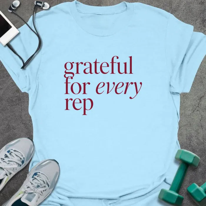 Light Blue t-shirt printed with "grateful for every rep" in burgundy