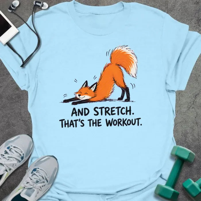 Light Blue t-shirt printed with "AND STRETCH. THAT'S THE WORKOUT." in black lettering, with a red fox in a stretching pose
