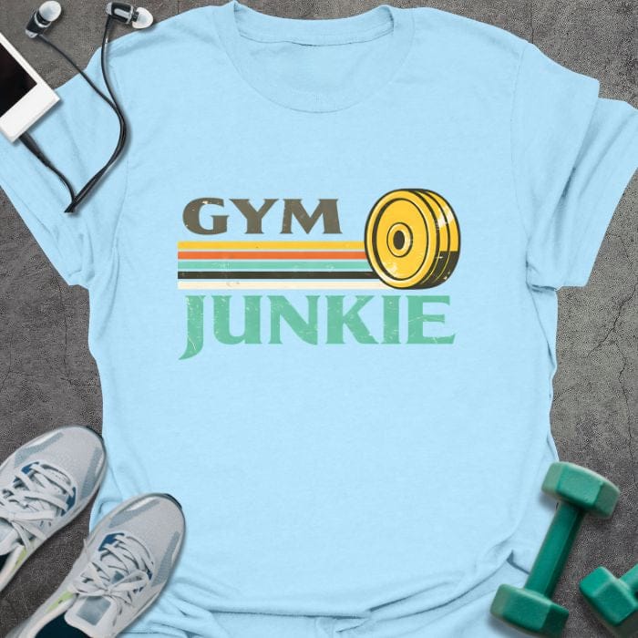 Light blue t-shirt printed with "Gym Junkie" in olive green, yellow, orange, white, with a yellow kettlebell and rainbow stripe