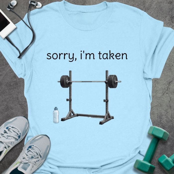 Light blue t-shirt printed with "sorry, i'm taken", with a barbell with weights