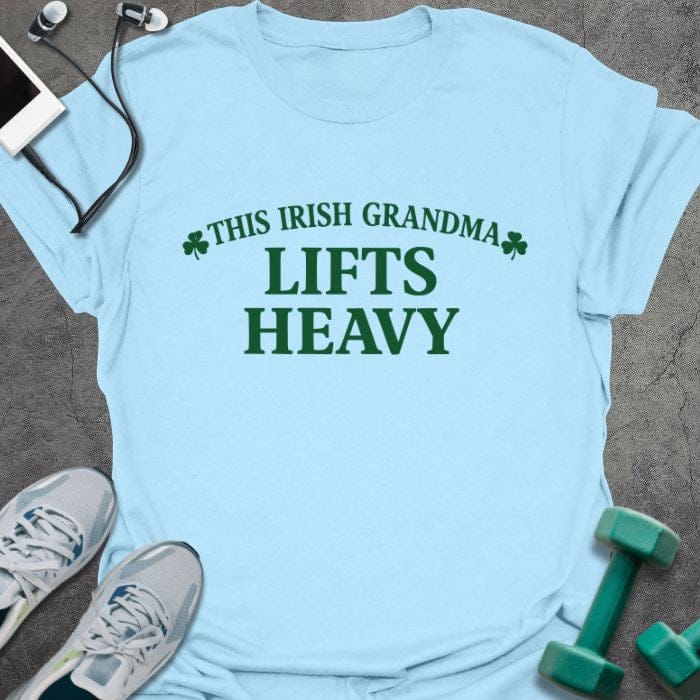 Light blue t-shirt printed with "This Irish Grandma Lifts Heavy" in green, with clover