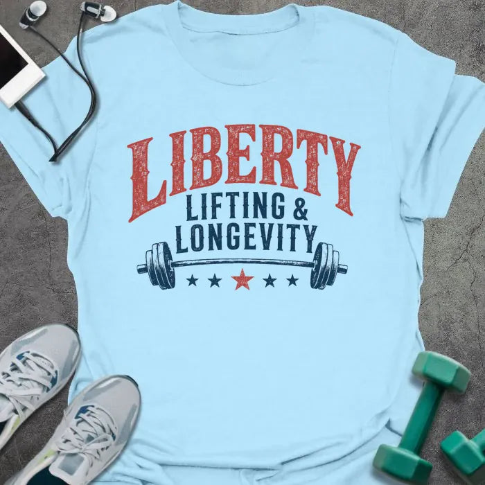 Light blue t-shirt printed with "Liberty Lifting & Longevity" in blue and red, with a barbell and stars