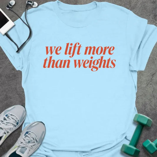 Light Blue t-shirt printed with "we lift more than weights" in red italic script