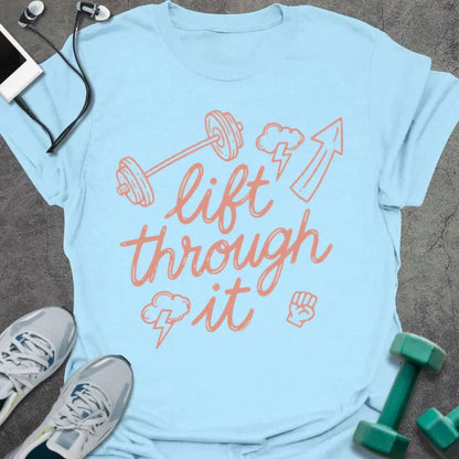 Light blue t-shirt printed with "lift through it" in orange, with dumbbell, arrow up, fist graphics