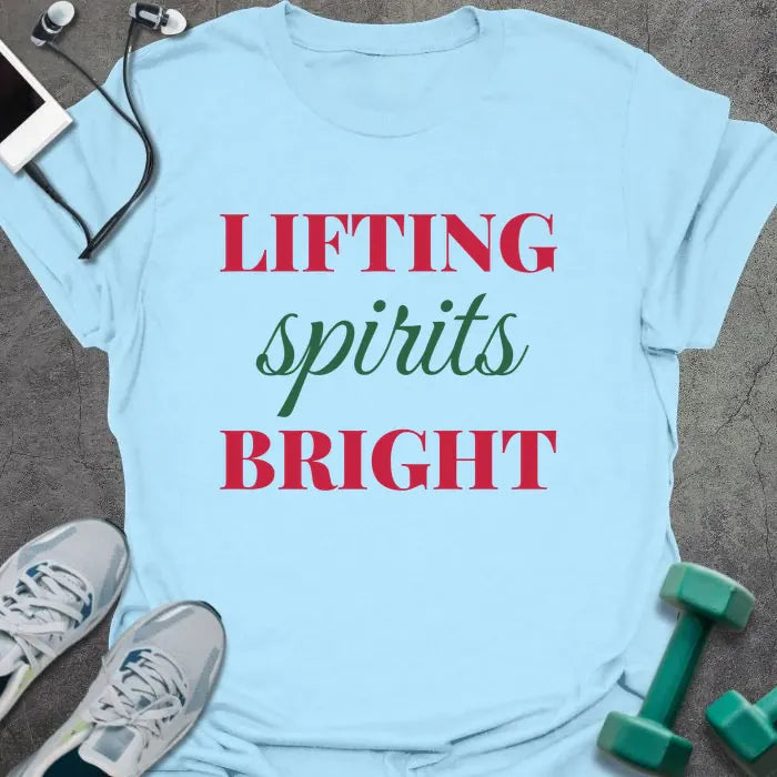Light blue t-shirt printed with "LIFTING spirits BRIGHT" in red and green