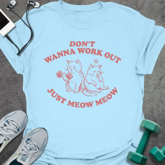 Light blue t-shirt printed with "Don't Wanna Work Out Just Meow Meow" in pink, with an illustration of two cats