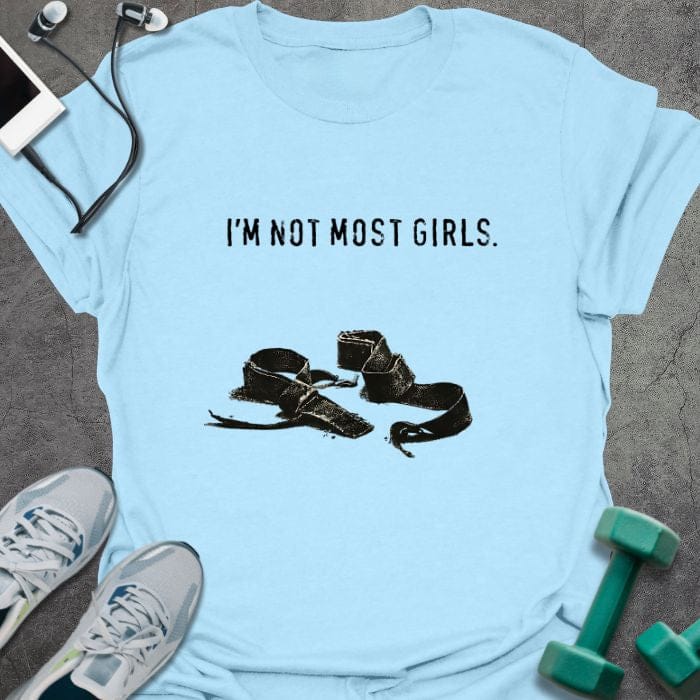Light blue t-shirt printed with "I'm Not Most Girls.", with lifting straps