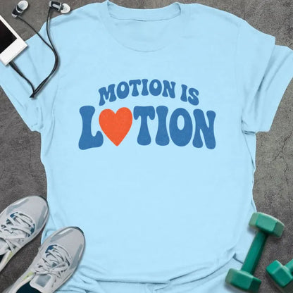 Light Blue t-shirt printed with "MOTION IS LOTION" in blue and orange, with heart icon