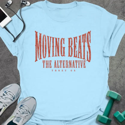 Light Blue t-shirt printed with "MOVING BEATS THE ALTERNATIVE TRUST US" in coral