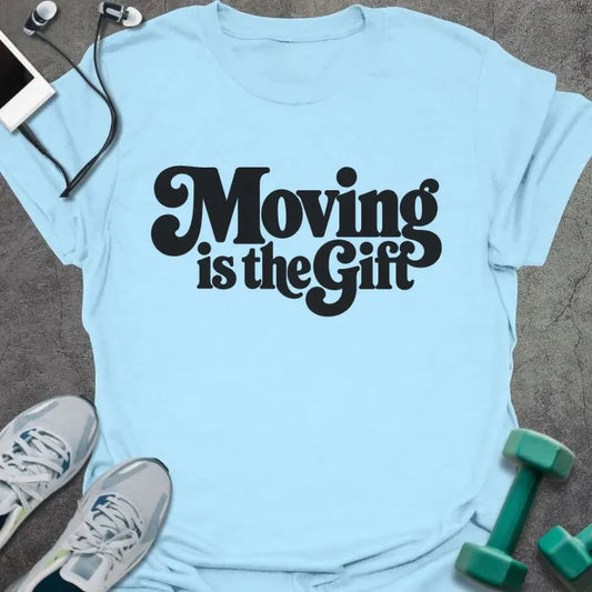 Light Blue t-shirt printed with "Moving is the Gift" in black groovy retro lettering