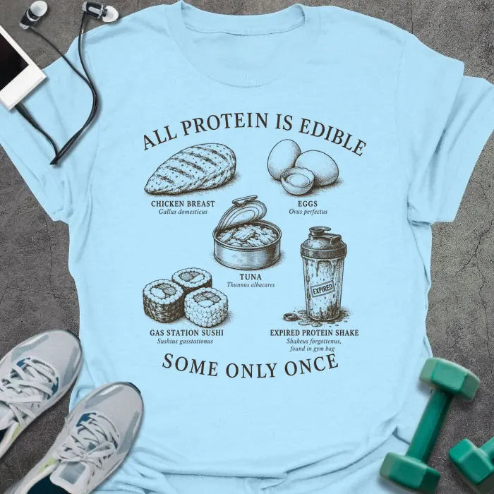 Light Blue t-shirt printed with "ALL PROTEIN IS EDIBLE" in black text with sepia-tone engraving style illustrations and 'SOME ONLY ONCE' at bottom