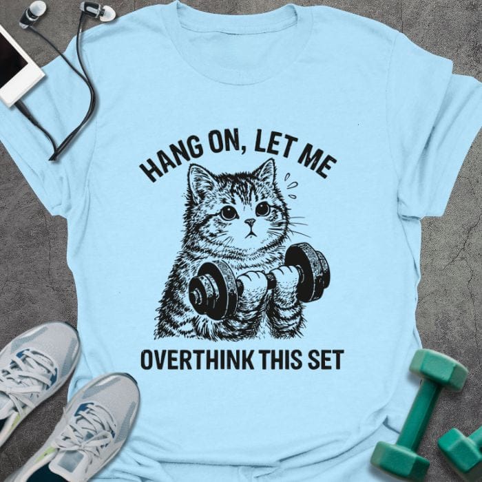 Light blue t-shirt printed with "Hang on, Let Me Overthink This Set", with a cat holding dumbbells
