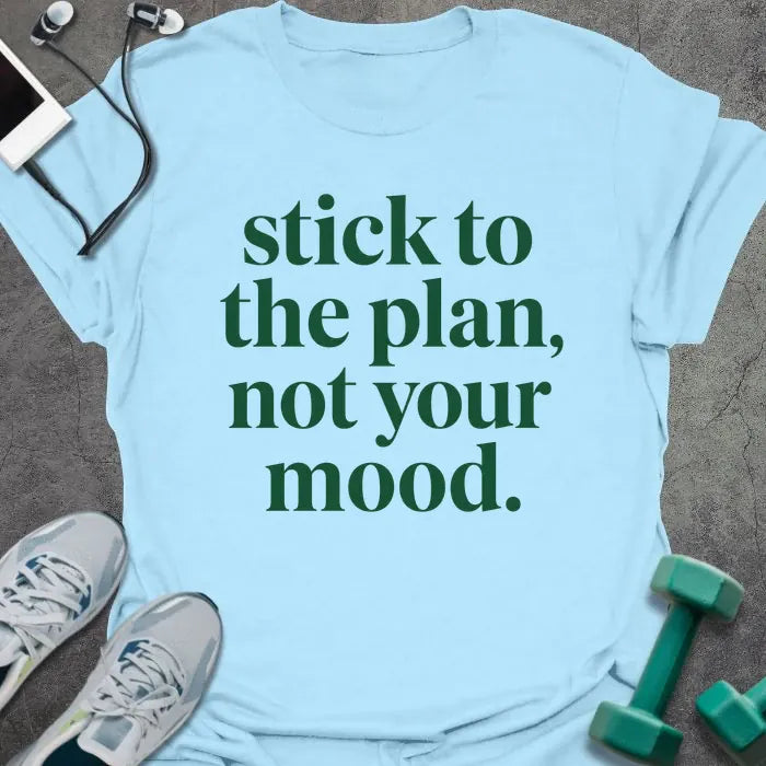 Light blue t-shirt printed with "stick to the plan, not your mood." in green