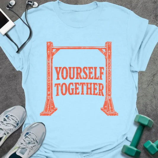 Light blue t-shirt printed with "Yourself Together" in coral, with a weight rack frame