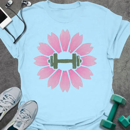 Light blue t-shirt with an illustration of pink sakura flowers surrounding a dumbbell in pink and green