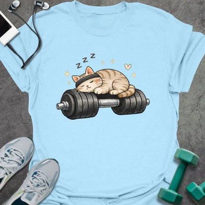 Light blue t-shirt with a sleeping cat on a dumbbell in tan, white