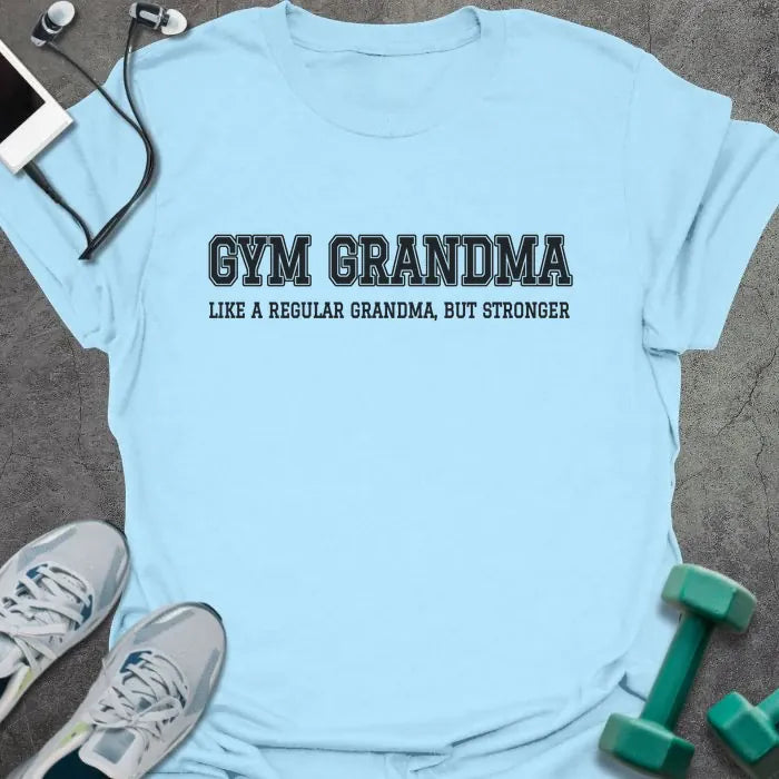 Light blue t-shirt printed with "GYM GRANDMA, LIKE A REGULAR GRANDMA, BUT STRONGER" in charcoal varsity letters