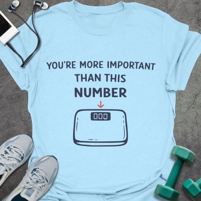 Light blue t-shirt printed with "You're More Important Than This Number", with scale illustration