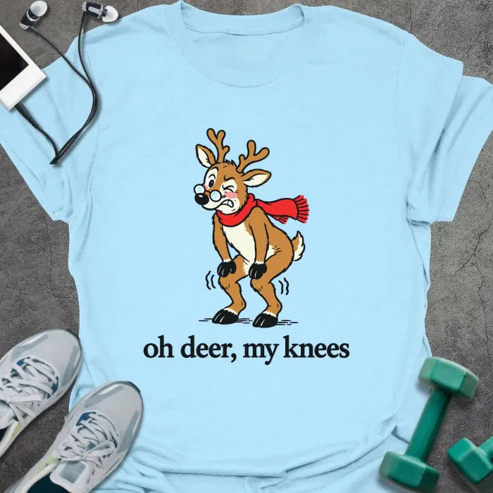 Light blue t-shirt printed with "oh deer, my knees" in black, with a vintage cartoon reindeer in glasses and a red scarf holding its knees