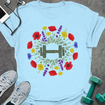 Light blue t-shirt with an illustration of multicolor wildflowers surrounding a dumbbell in multicolor